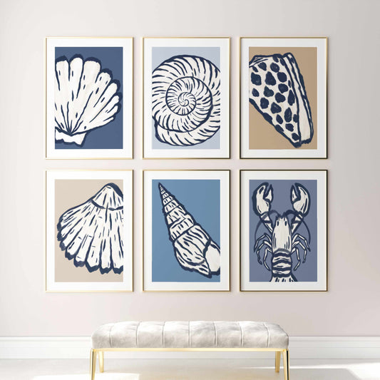 a white bench sitting in front of four framed pictures