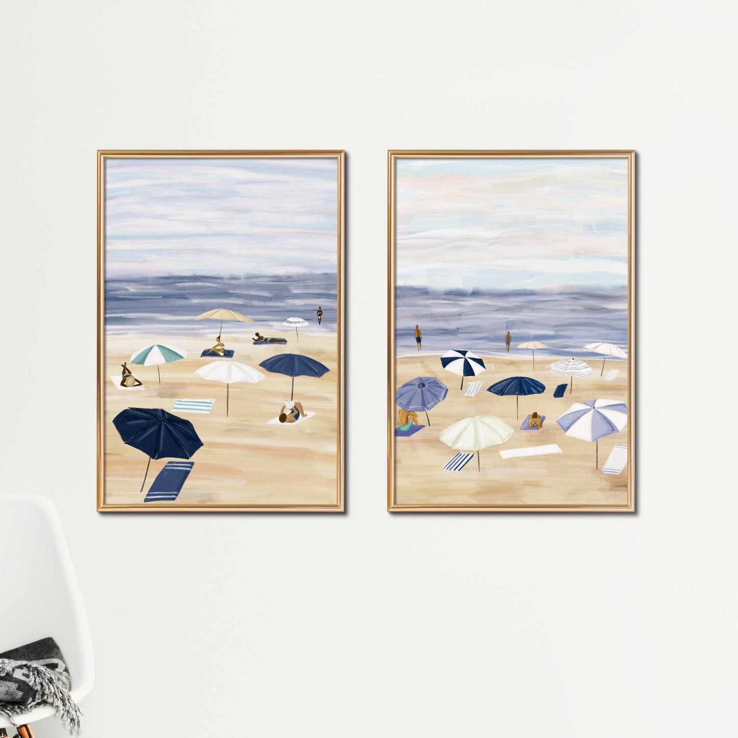 two paintings of beach umbrellas on a white wall