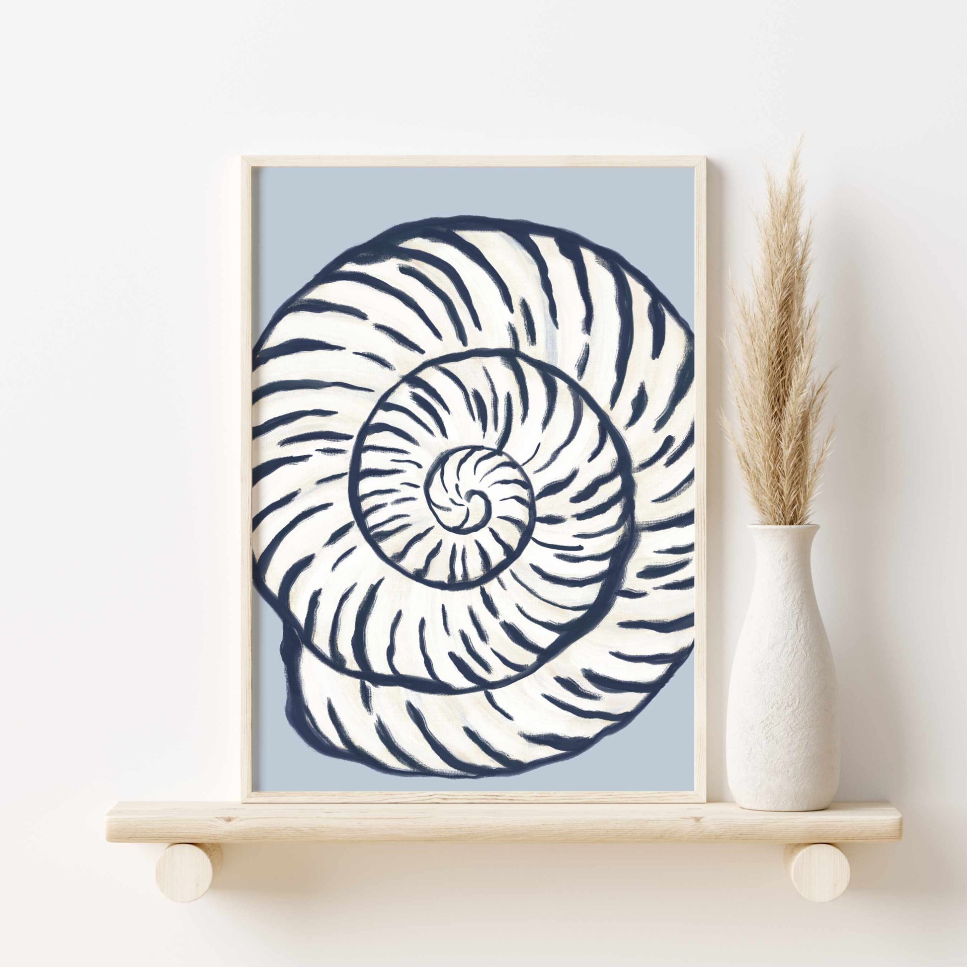 a picture of a shell on a shelf next to a vase