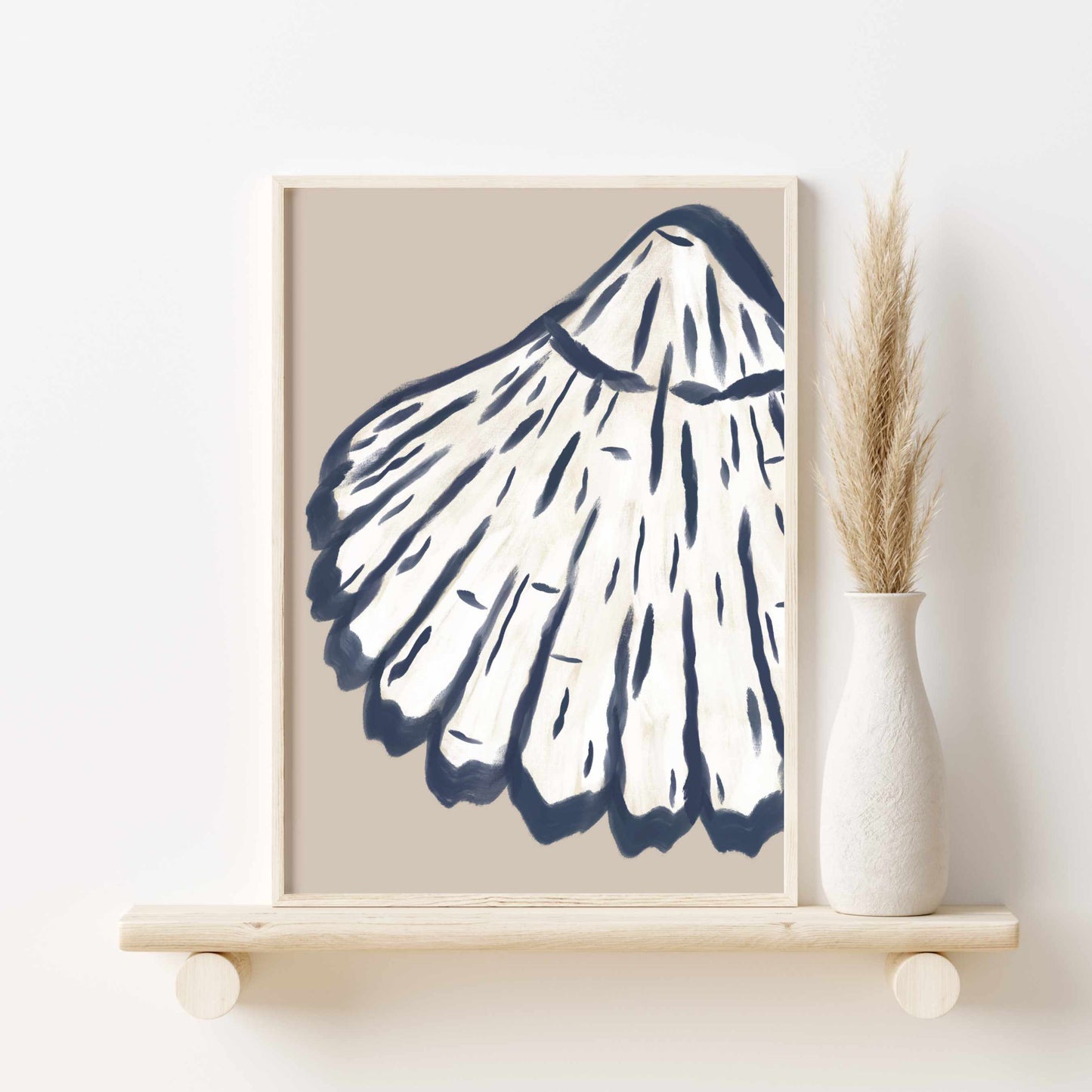 a picture of a shell on a shelf next to a vase