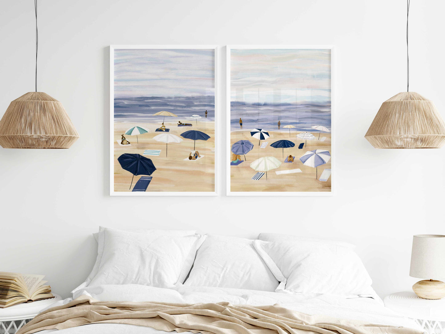 two paintings of umbrellas on a white wall above a bed